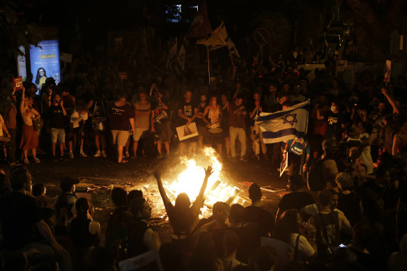 Protesters gather around a bonfire in Tel Aviv on the second day of demonstrations demanding a Gaza deal.