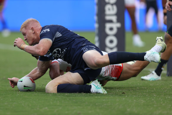 Griffin Neame of the Cowboys scores a try.