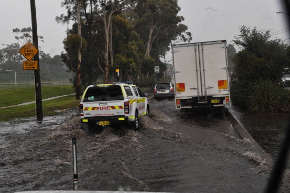 Heavy showers cause flooding along Forest Road, Belrose, on Sydney's northern beaches, on Monday.