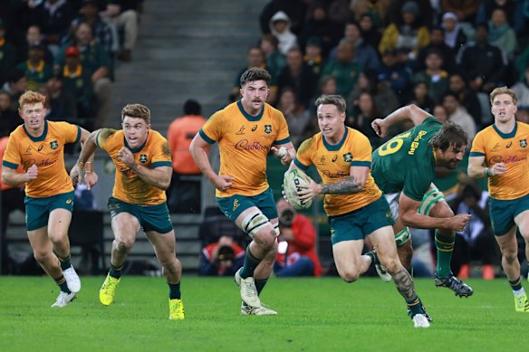 Australia’s Corey Toole, front, breaks away from South Africa’s Eben Etzebeth 