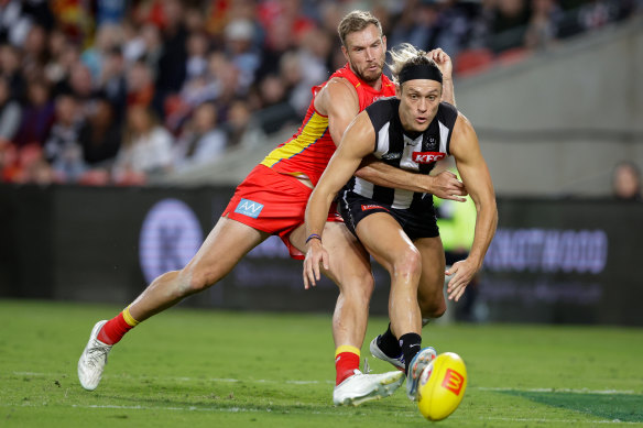 Collingwood’s Darcy Moore locks horns with Gold Coast’s Sam Day.