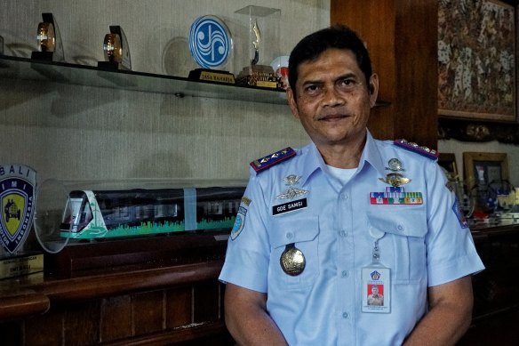 I Gede Wayan Samsi Gunarta, head of the Bali government’s transportation department, stands next to an ART model from China. 
