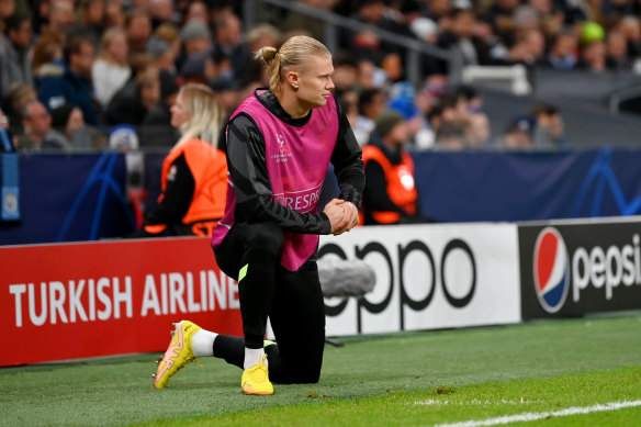 Erling Haaland watches on from the sideline.