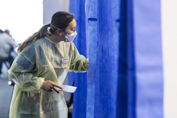 A health worker in a vaccination hub at Whitten Oval on Saturday.