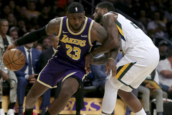 Lakers forward LeBron James, left, drives past Utah's Royce O'Neale. 
