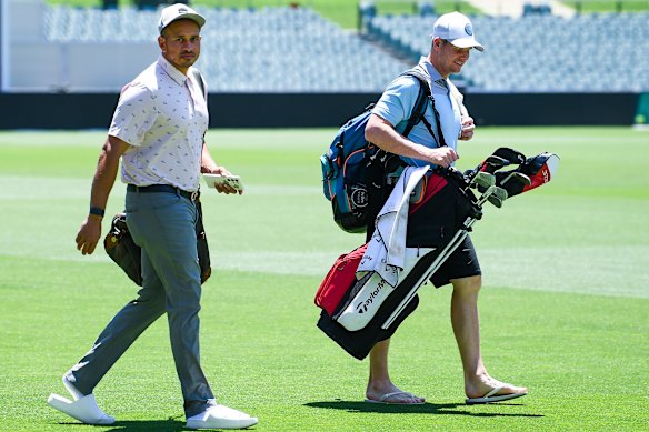 Usman Khawaja and Steve Smith on the way to the course in January last year.