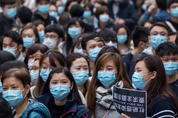 Medical workers wearing protective masks gather during a protest outside the Hospital Authority's head office in Hong Kong on Tuesday.