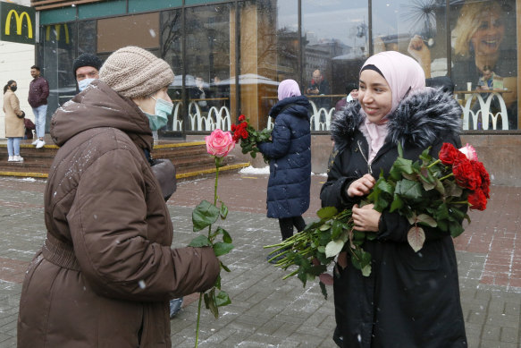 An activist in a hijab presents a flower to a woman passerby to mark the World Hijab Day in Kyev, Ukraine, on February 1.