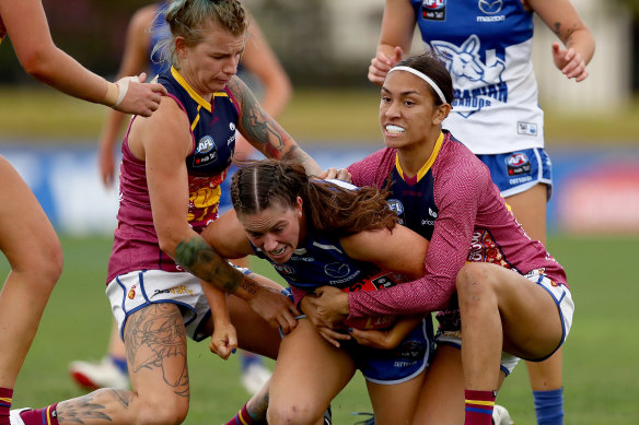 Grace Campbell, centre, is tackled. 