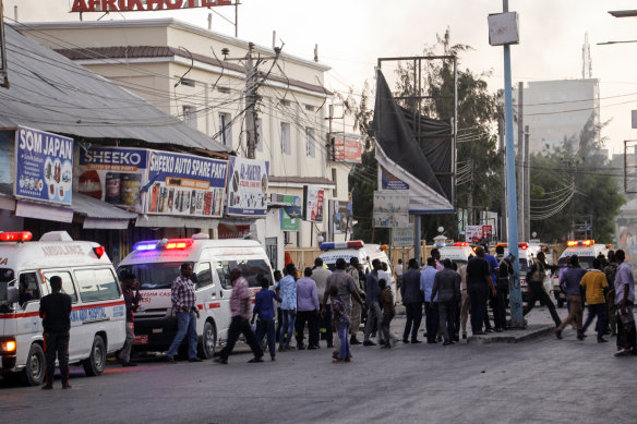 Ambulances and security forces gather on the street outside the Afrik hotel in Mogadishu.