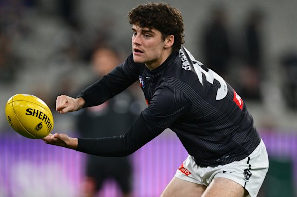 Sam Swadling of the Magpies warms up.