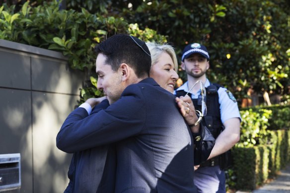 Police Minister Yasmin Catley hugs David Ossip, president of the Jewish Board of Deputies at the Emanuel Synagogue at Woollahra on Friday night.