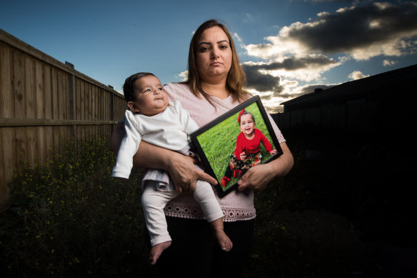Harpinder Kaur Romana with her youngest daughter Arzoyi and a picture of oldest daughter Ashlyn. The family has been separated from Ashlyn for more than a year.