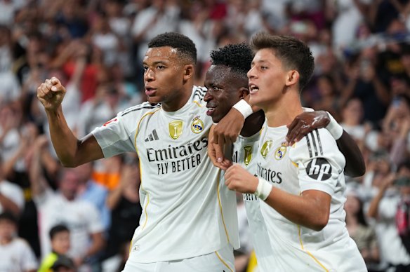 Arda Güler (right) celebrates a Real Madrid goal with Vinicius Junior (centre) and Kylian Mbappe.