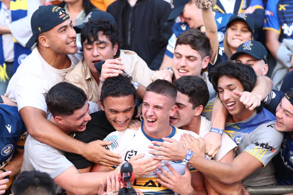 Will Penisini (back left with cap) celebrates good mate Jake Arthur’s NRL debut for Parramatta at last year’s Magic Round.