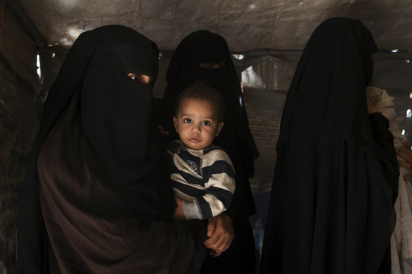 Australian Zahra Ahmed (left) holding her son Ibrahim in the al-Hawl camp in north-east Syria in October 2019. 