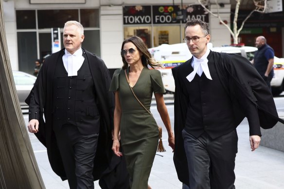 Bianca Rinehart enters court flanked by lawyers, with Christopher Withers SC on the left.