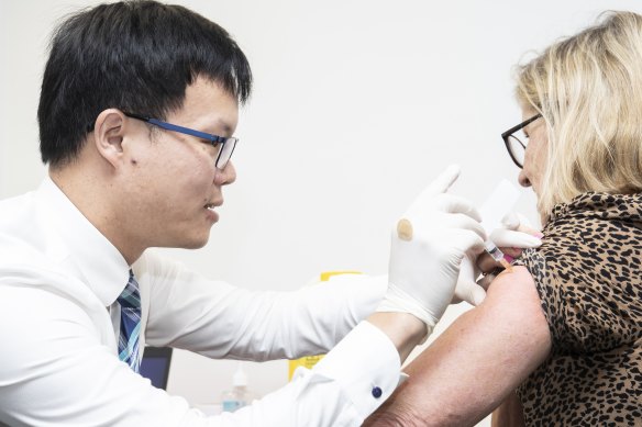 A health worker is vaccinated as part of the 1b rollout which started yesterday.