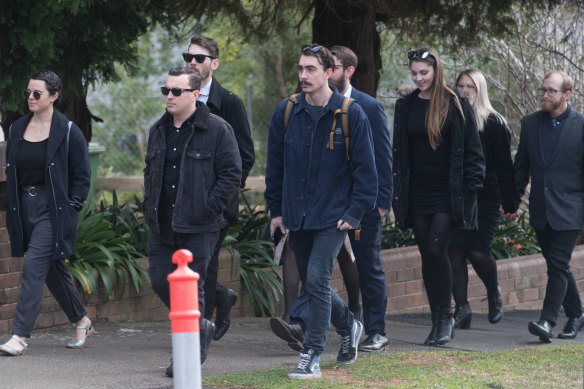 Friends of Lucas Fowler arrive for the service.