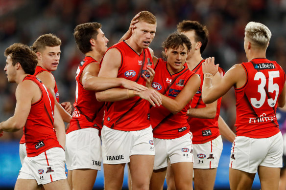 Peter Wright of the Bombers celebrates a goal with Tex Wanganeen in round three. 