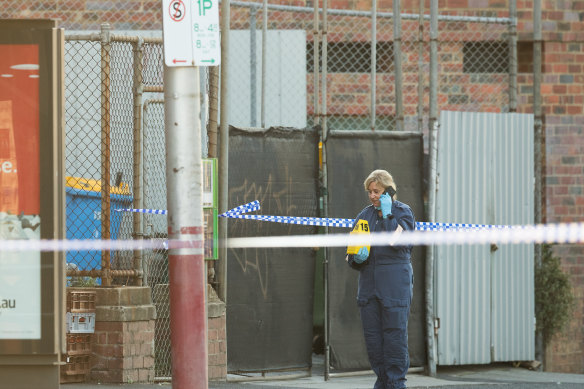 Police at a tram stop in Kew where a man was stabbed to death.