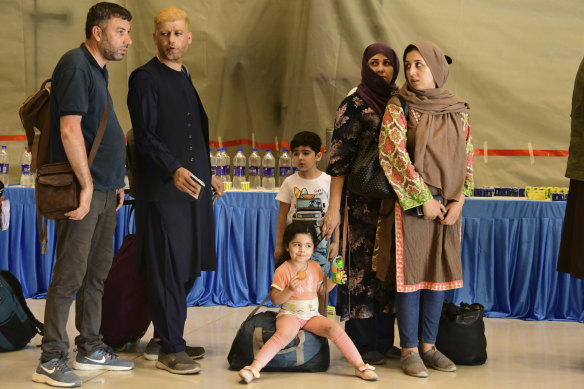 People evacuated from Kabul arrive at Hindon Air force base near New Delhi, India on Sunday. Their flight carried 168 people, according to an Indian government spokesman.