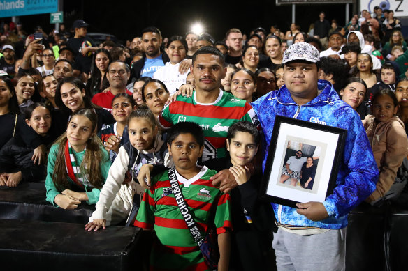 Tyrone Munro with family, friends and Souths fans after the match against Penrith last year.