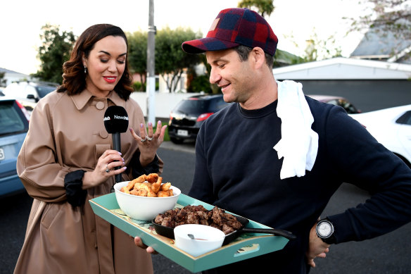 New Zealand Labour Party leader Jacinda Ardern's partner Clarke Gayford delivers home-cooked food to the media waiting outside their house in Auckland.
