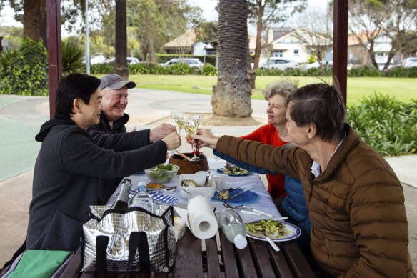 Sandra Gibbons, in the orange top, celebrates her birthday with friends. 