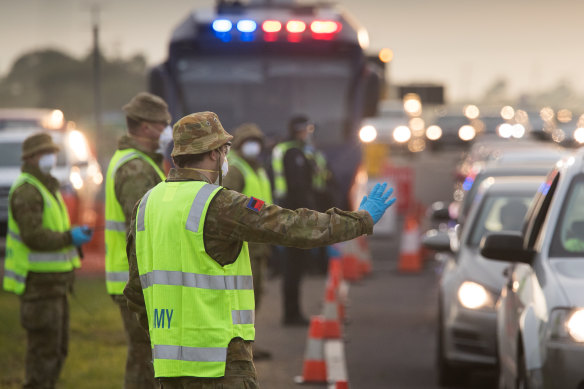 ADF personnel help police at a roadside checkpoint on the Geelong Freeway last week.