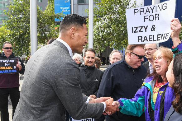 Israel Folau meets with supporters on his way into Melbourne's Federal Circuit Court this week.