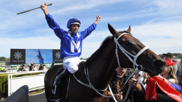 Simply the best: Hugh Bowman raise his arms in triumph as Winx returns from her 30th consecutive win in the Apollo Stakes.