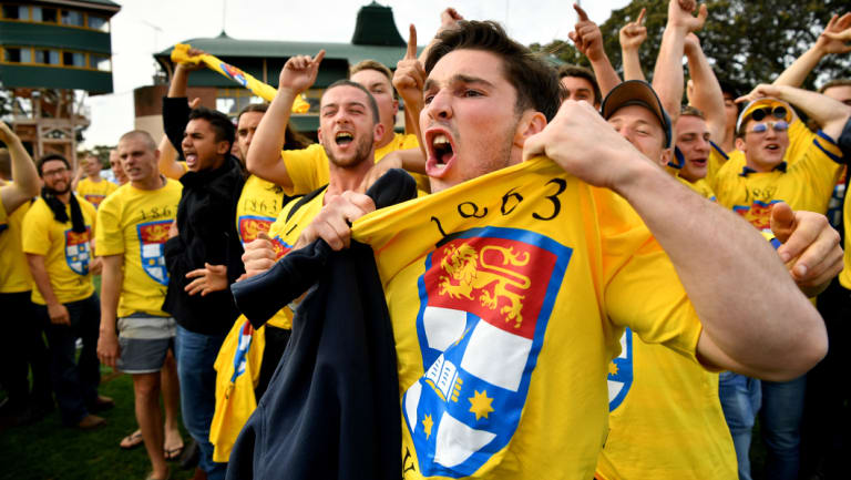 Canary yellow fever: Sydney University supporters taunt their Warringah counterparts .