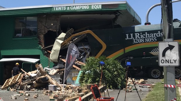 Driver dies after after garbage truck crashes into Brisbane tent store