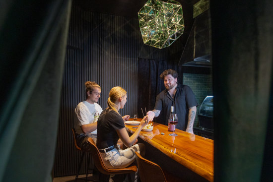 Emerald City chef Joel Alderdice behind the counter of his four-seat restaurant.