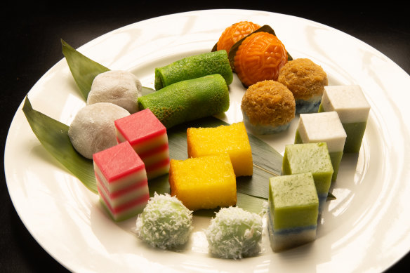 A plate of colourful sweets known as kueh.