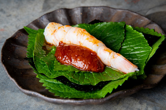 Skull Island prawn “taco” served on aromatic leaves with chilli sambal.