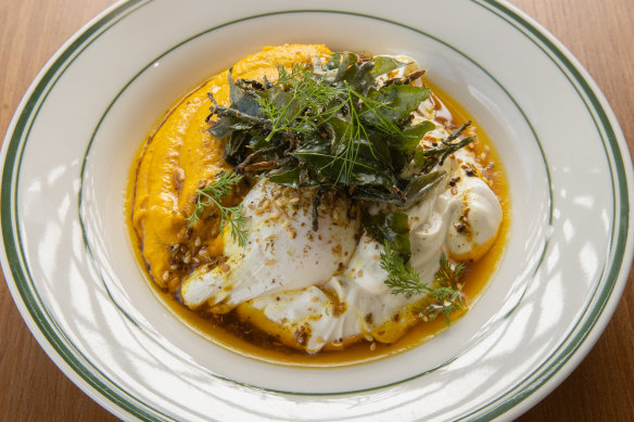 Vadouvan eggs: Poached eggs drizzled with spiced ghee and garnished with zaatar over herbed carrot puree and lemon labne.