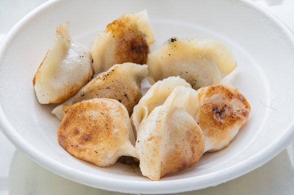 Plump fried pork and cabbage dumplings come eight to a serve.