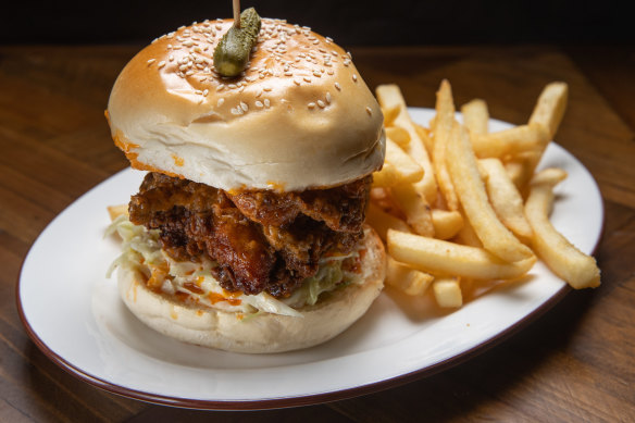 The buffalo chicken burger is a big hunk of fried chicken dripping red oil, bolstered by coleslaw. 