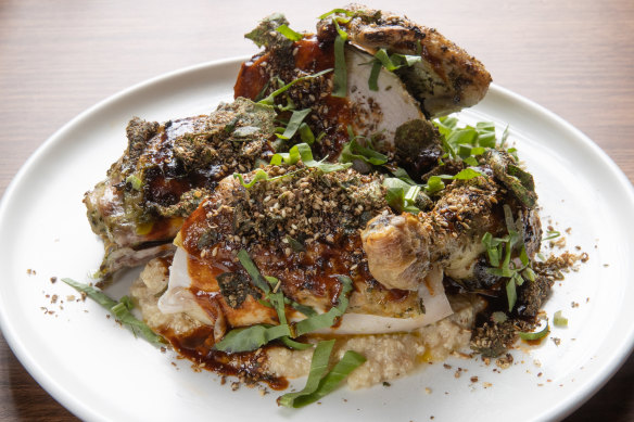 Roast chicken, crusted with saltbush zaatar, rests on a bread sauce.