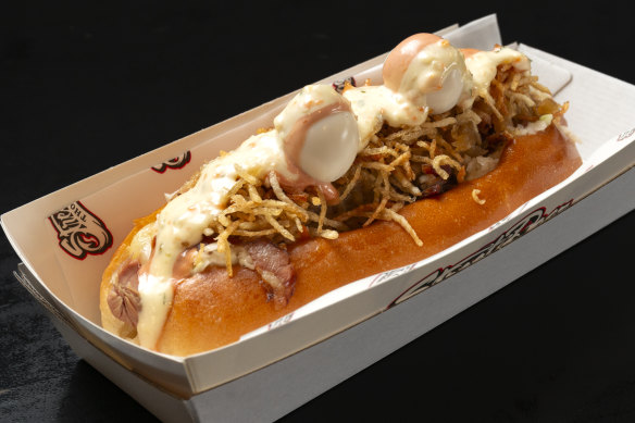 The Paco hot dog topped with melted mozzarella, pineapple sauce, “pink sauce”, matchstick potato
crisps and quail eggs.