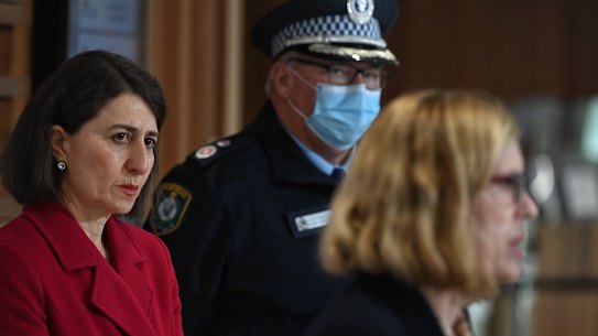 NSW Premier Gladys Berejiklian and Deputy Commissioner Gary Worboys listen as Chief Health Officer Dr Kerry Chant delivers the COVID numbers. 