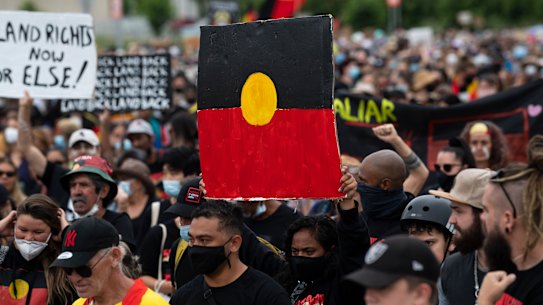 The protesters marched from the city centre to the lawns of Old Parliament House.