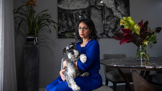 Jo Cooper and her pet schnauzer Angus in her Darlinghurst apartment. 