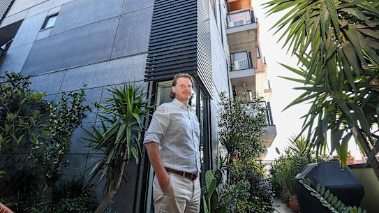 Tony Weir in his apartment. The apartment block has been deemed to have flammable cladding even though there appears to be agreement between state and local govt that it does not.
