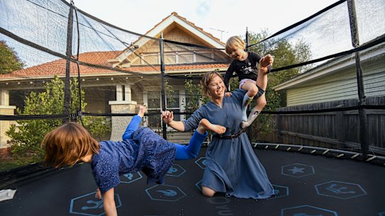 Physiology researcher Sarah Haas-Lockie, with daughters Lillian and Vivienne, has found the overwhelm lag from pandemic working parent life is tough enough to consider cutting back.