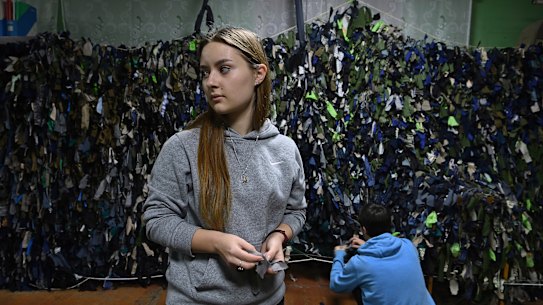 Tetiana Onopriienko 16 years old in her last year of high school is now volunteering to make camouflage nets in a community shelter in Uman.