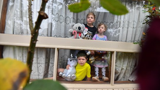 Alice Gibson’s children Fergus, 8 (in black), Harley, 6 (in yellow), Lorelei, 4 (in pink) with Geoff the koala. 
