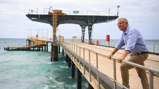 Prime Minister Scott Morrison poses for photographs on the Christmas Island jetty.